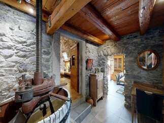 Step into rustic charm with this stunning property featuring exposed stone walls and wooden beams.