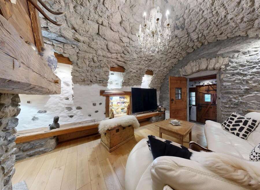 Step into rustic elegance with this stunning property, featuring a unique stone-walled interior and a cozy ambiance.