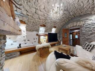 Step into rustic elegance with this stunning property, featuring a unique stone-walled interior and a cozy ambiance.
