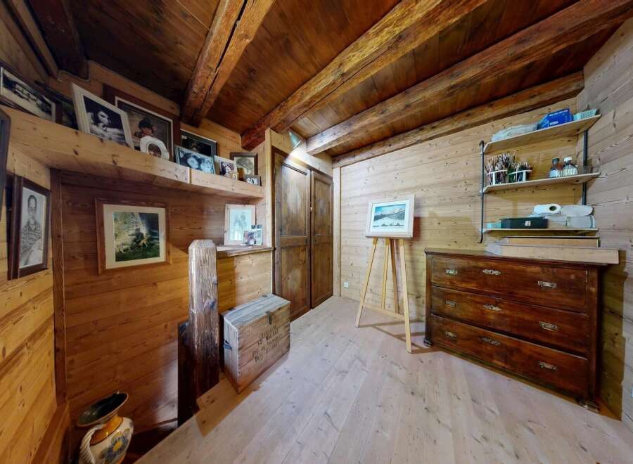 This charming property boasts a rustic interior with wooden walls and ceilings, creating a warm and inviting atmosphere.