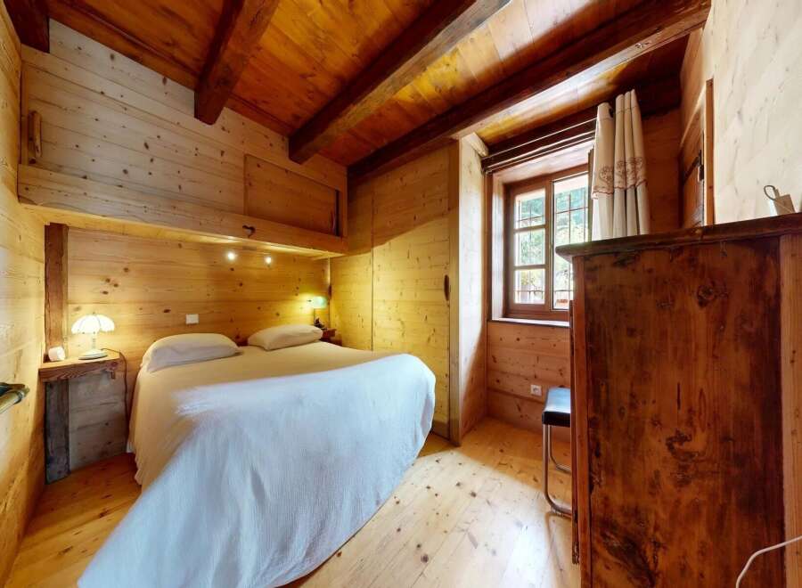 Step into this charming wooden bedroom, a cozy retreat perfect for relaxation.