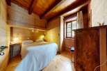 Step into this charming wooden bedroom, a cozy retreat perfect for relaxation.