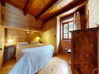 Step into this charming wooden bedroom, a cozy retreat perfect for relaxation.