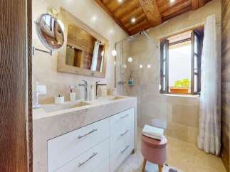 Step into luxury with this stunning bathroom featuring a double vanity and a spacious shower.