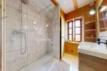 Step into a luxurious bathroom retreat! This stunning space features a modern shower with elegant marble-like tiles, complemented by a stylish vanity.