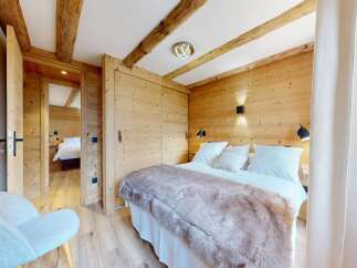 Step into this cozy bedroom, featuring stunning wooden accents and a warm, inviting atmosphere.