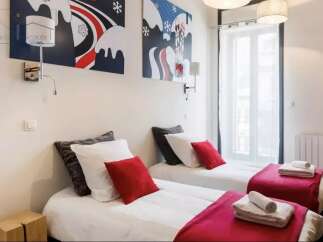 This charming bedroom features two twin beds, perfect for guests or roommates.