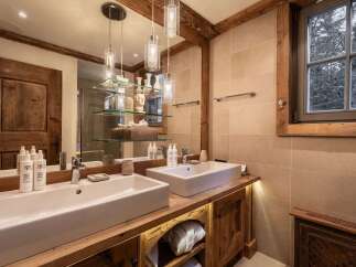 Experience luxury in this stunning bathroom featuring a double vanity with sleek, modern sinks.
