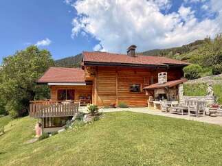 Discover the charm of this stunning wooden chalet nestled in a picturesque mountain setting.