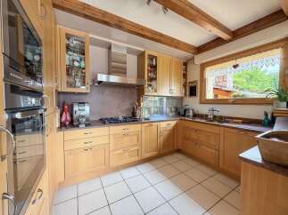 This stunning kitchen boasts a warm and inviting atmosphere, perfect for culinary enthusiasts.