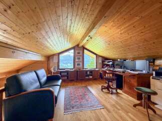 This stunning property boasts a unique, light-filled interior with a cozy, wooden ceiling.