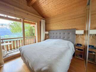 Experience the tranquility of this stunning bedroom with breathtaking mountain views.