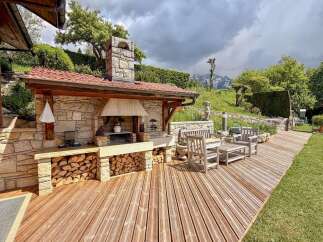Discover the charm of this stunning outdoor kitchen, perfect for entertaining and enjoying the beautiful surroundings.