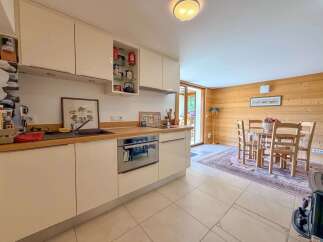 This charming kitchen boasts a modern design with sleek cabinetry and a built-in oven.