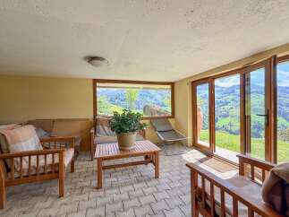 Enjoy breathtaking mountain views from this cozy sunroom.