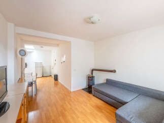 Discover this charming property featuring a cozy living space with a comfortable sofa and a unique fireplace.