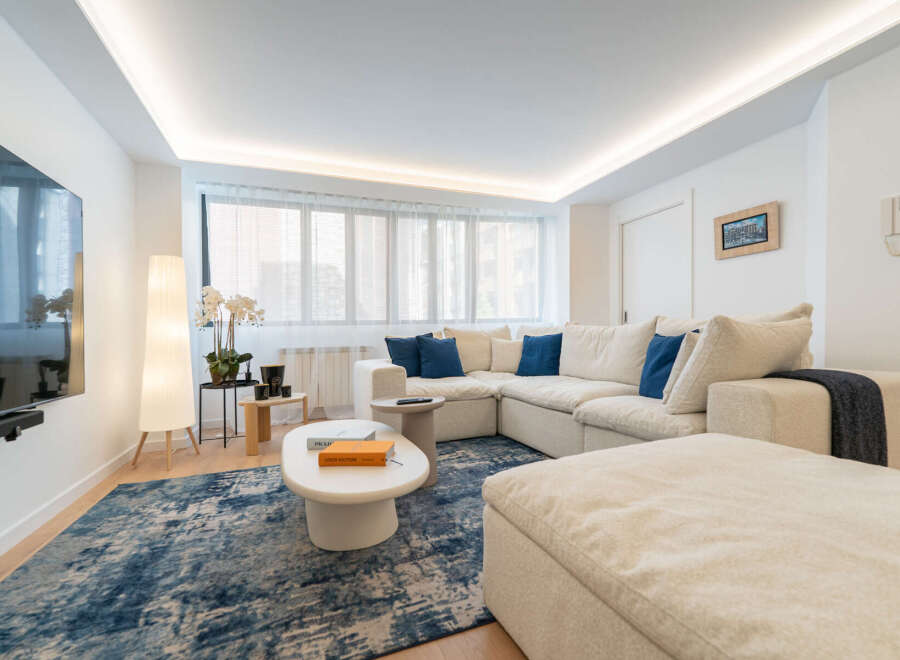 Step into luxury with this stunning living space! Featuring a modern sectional sofa, a stylish coffee table, and a plush rug, this home offers both comfort and elegance.