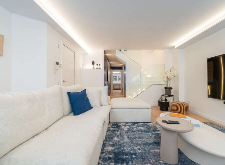 Discover modern living in this stunning property! This home features a bright and airy living room with a comfortable sectional sofa and a stylish coffee table.