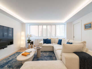 Experience modern living in this stunning property! The spacious living room features a large, comfortable sectional sofa, perfect for relaxing.