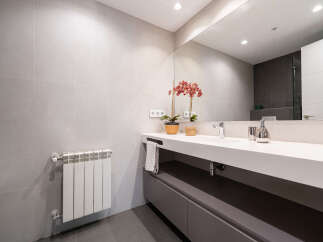This modern bathroom boasts a sleek design with a minimalist aesthetic.