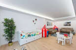 This spacious room is designed for family fun and relaxation, featuring a comfortable daybed with playful bedding and two circus-themed tents.