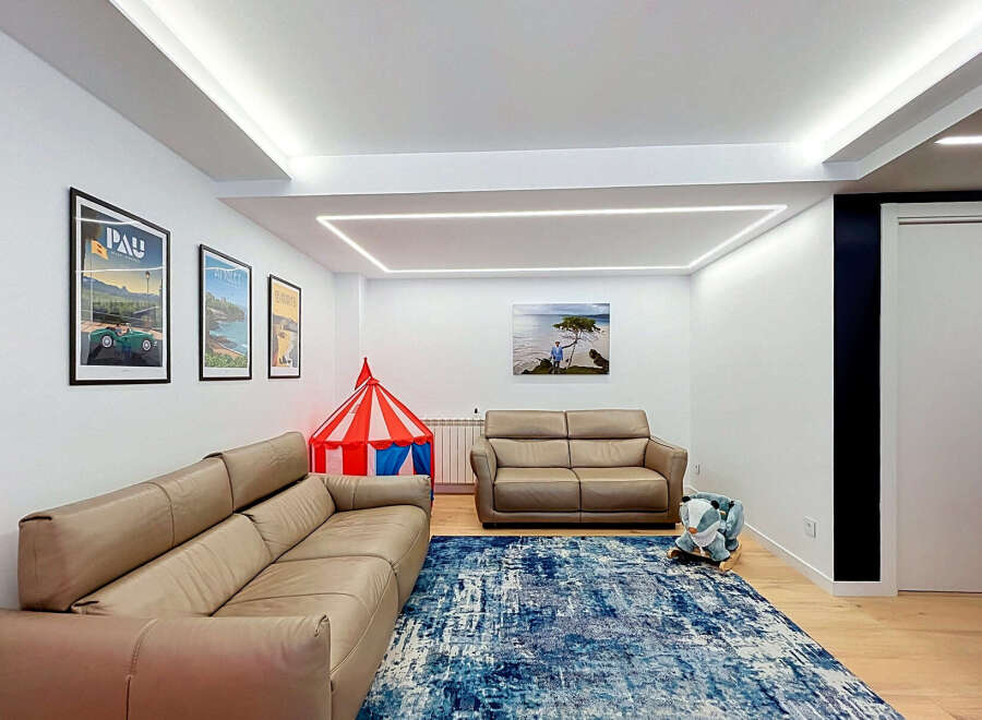 This spacious living room features a large, comfortable sectional sofa perfect for family gatherings.