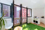 Experience seamless indoor-outdoor living with this modern apartment featuring expansive bi-fold doors that open onto a charming balcony.