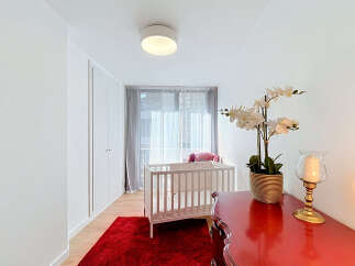 Discover a serene nursery space featuring a classic white crib adorned with soft bedding, perfect for a little one.