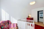 This charming nursery features a cozy crib adorned with a soft white blanket, perfect for a little one's peaceful slumber.