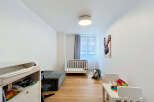 This charming nursery features a comfortable crib and a changing station, perfect for a growing family.