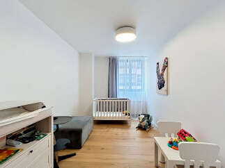 This charming nursery features a comfortable crib and a changing station, perfect for a growing family.