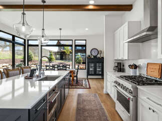 This stunning kitchen boasts a modern design with sleek countertops and stainless steel appliances, perfect for culinary enthusiasts.