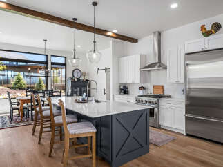 This stunning kitchen boasts a modern design with a spacious island, perfect for meal preparation and entertaining.