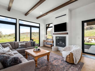 Experience luxury living in this stunning property featuring a spacious living room with large windows that offer breathtaking views.