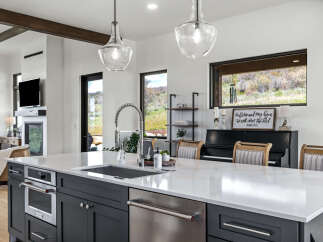 This stunning kitchen boasts a modern design with a spacious island, perfect for culinary creations and entertaining.