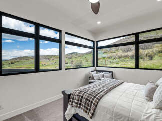 Experience the beauty of nature from the comfort of this stunning bedroom.