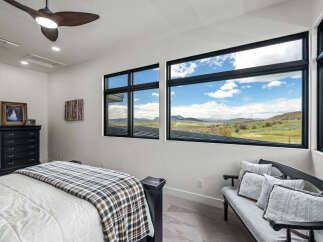 Experience luxury living in this stunning bedroom with breathtaking views.