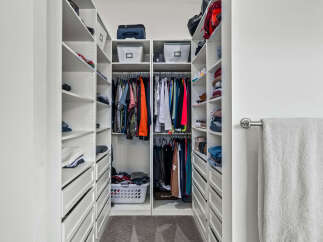 Step into luxury with this meticulously organized walk-in closet.