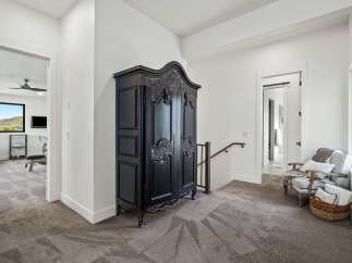 Step into luxury with this stunning property, featuring a spacious hallway adorned with elegant decor.
