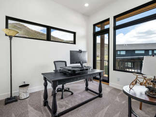 This stunning home office boasts a modern design with ample natural light.