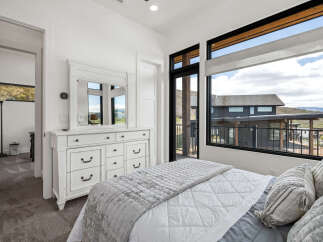Experience luxury living in this stunning bedroom with breathtaking views.