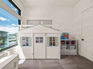 This charming children's playhouse offers a whimsical retreat within a modern home.