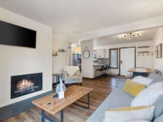 Step into this inviting living space, featuring a cozy fireplace and a sleek mounted TV, perfect for relaxing evenings.