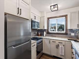 Step into this beautifully designed kitchen, featuring modern appliances and stylish cabinetry.
