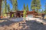 This stunning property boasts a modern architectural design with a warm, inviting wooden exterior.