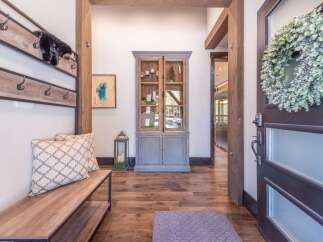 Step into luxury with this stunning entryway! Featuring a beautiful wooden bench, a stylish coat rack, and a charming cabinet, this space is both functional and inviting.