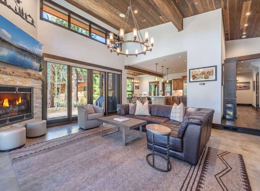 Experience luxury living in this stunning property, featuring a cozy fireplace and a spacious living area.
