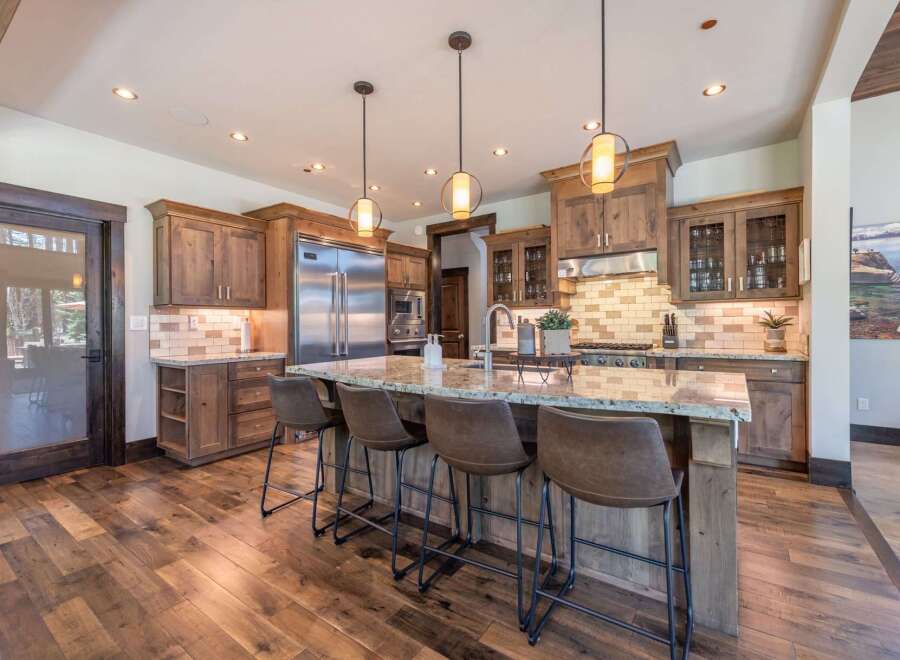 Step into luxury with this stunning kitchen! Featuring custom cabinetry, a spacious island with seating, and high-end appliances, this space is perfect for both cooking and entertaining.