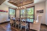 This stunning dining room boasts a rustic charm with its wooden ceiling and flooring, creating a warm and inviting atmosphere.