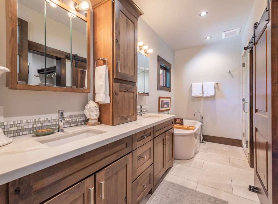 This luxurious bathroom features a stunning vanity with dual sinks, ample storage, and a beautiful countertop.
